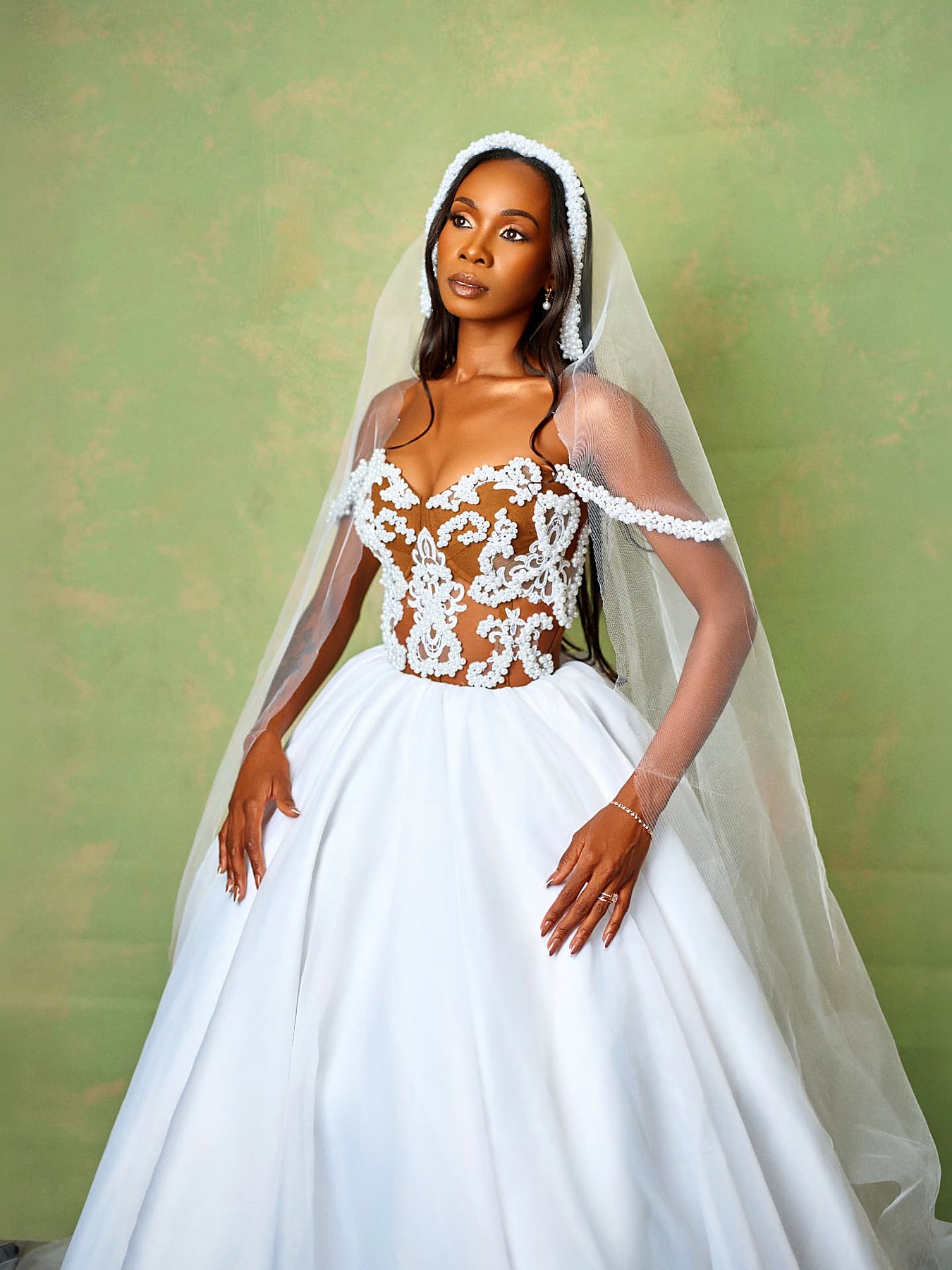 Real Foxxy bride in a pearl illusion corset ball gown with cathedral veil