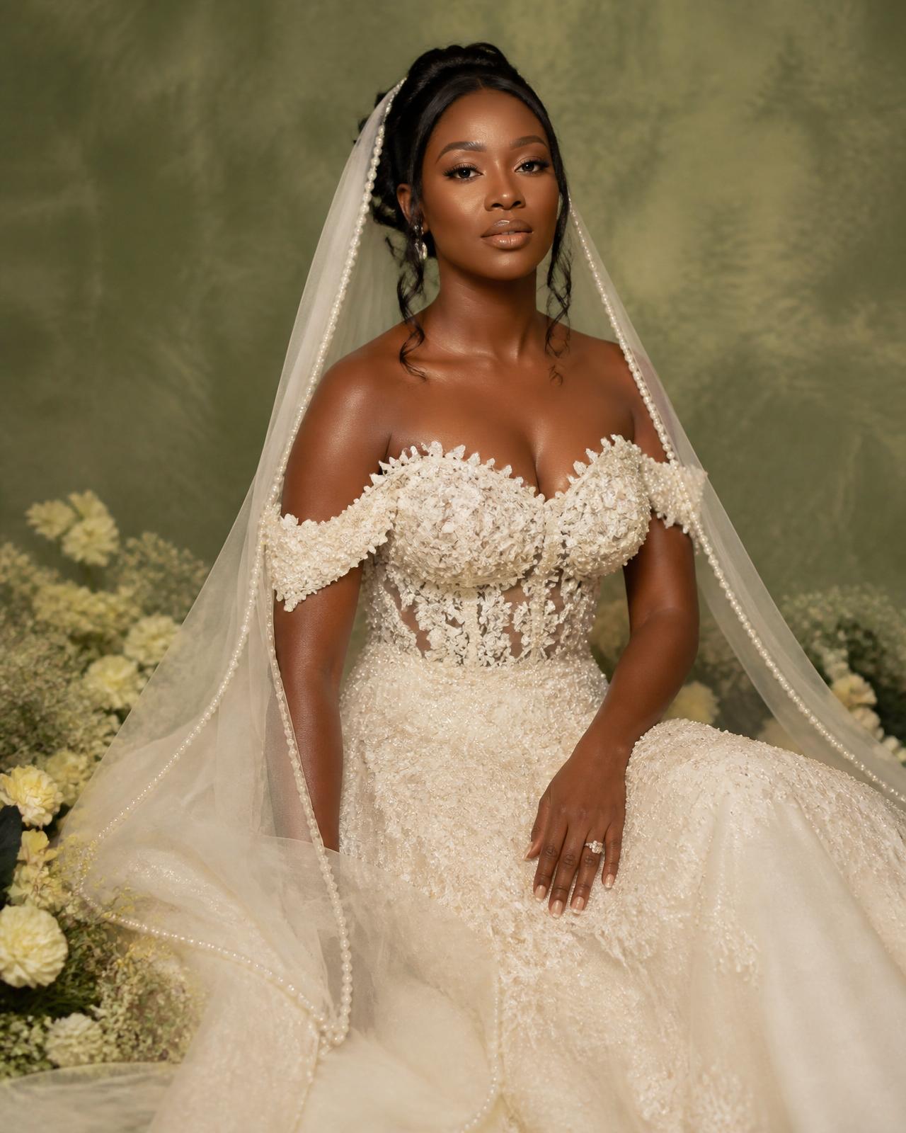 Bride in custom ivory gown standing in the warm light of the Namibian landscape